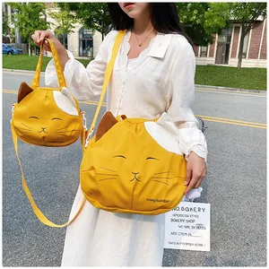 Outdoor shot of cute cat-shaped yellow canvas bags with 3D ears and adjustable straps