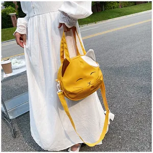 Detail of the yellow cat-shaped canvas bag with cute ears and adjustable shoulder strap