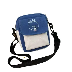 Blue and white canvas crossbody bag featuring a cute cartoon rabbit with shoulder strap