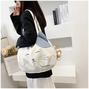 Detail of cute cat canvas tote bag with 3D ears and plush sheep charm accessory