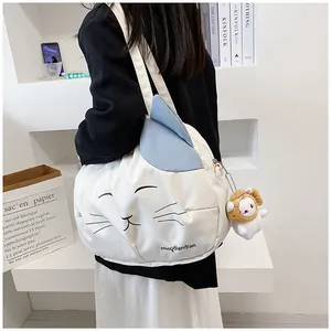 Detailed view of white canvas cat tote bag with 3D ears, embroidery and cute plush pendant