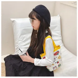 Detailed view of a cute canvas tote bag with rabbit and strawberry prints for kids