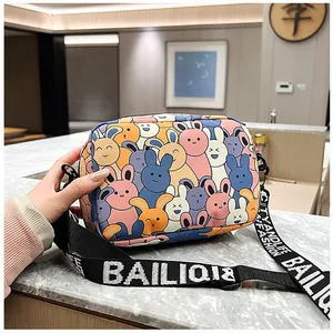 Detail of cartoon rabbit print crossbody bag with stylish wide branded shoulder strap