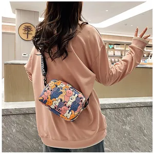 Detailed back view of a crossbody bag with colorful cartoon bunny print and wide strap
