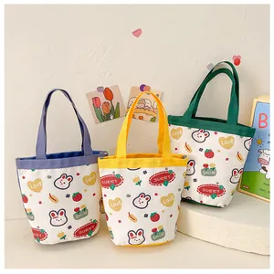 Three mini canvas lunch bags with cute cartoon rabbits and colorful top handles