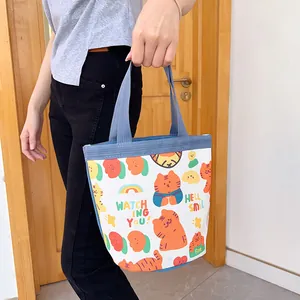 Canvas lunch bag with cute orange tiger prints and blue handles for daily use
