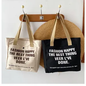 Detail view of canvas tote bags with outer pockets and sturdy handles in beige and black