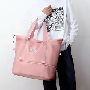 Pink large capacity waterproof travel bag with bottom expansion layer and sturdy handles