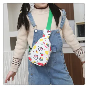 Detailaufnahme der Kinder-Brusttasche mit Hasenmotiven, Erdbeeren und grünem Gurt