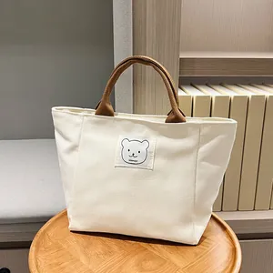 Japanese style canvas bucket bag in beige with cute bear patch and brown handles