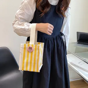 Japanese style yellow striped canvas mini handbag with cute cartoon brooch decoration