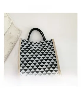 Detailed macro view of geometric triangle pattern and linen fabric on tote bag