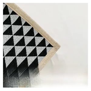Close-up of the woven jute fabric edge and black white geometric triangle pattern