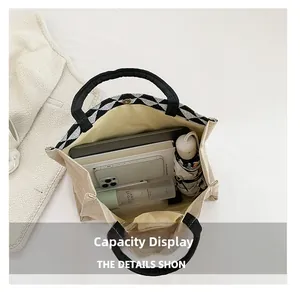 Spacious interior of canvas tote bag with checkerboard trim showing storage capacity
