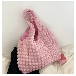 Close-up of pink popcorn textured fabric and spacious interior of the soft hobo shoulder bag