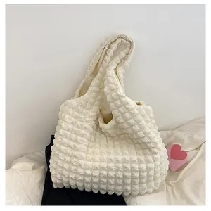 Macro detail of the creamy white bubble texture fabric on this minimalist tote bag