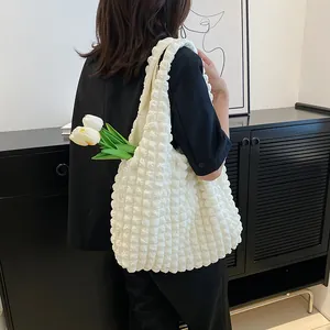 White puffer tote bag with bubble texture shown on shoulder for a minimalist look