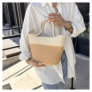 Detail of a two-tone woven tote bag in cream and light brown with soft cotton rope texture