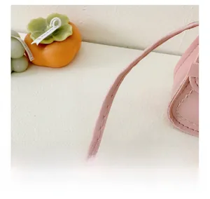 Detailed close-up of a pink girl's bag shoulder strap with neat stitching and PU texture