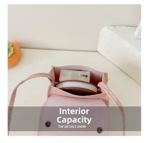 Pink bow mini crossbody bag interior showing storage capacity for small items