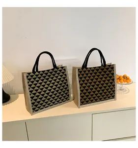 Modern linen tote bag with geometric triangle patterns and woven rope handles