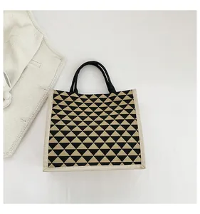 Detail shot of the modern geometric triangle pattern on a durable linen tote bag