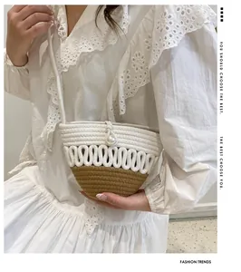 Detail of hand-woven crossbody beach bag with a white pearl buckle and wavy texture