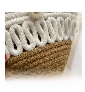 Detailed view of woven straw bag with cream rope texture and large pearl accent