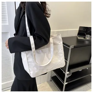 White large capacity fashion tote bag worn over shoulder in office setting