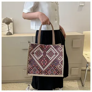 Detail of bohemian woven tote bag with colorful geometric patterns and jute texture