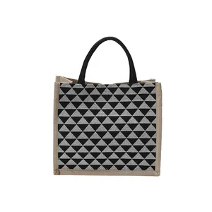 Minimalist jute tote bag with geometric triangle pattern and round black handles
