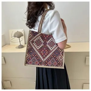 Ethnic style woven tote bag featuring colorful geometric patterns and rope handles