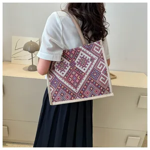 Ethnic style woven tote bag shown from a back perspective to display size and fit
