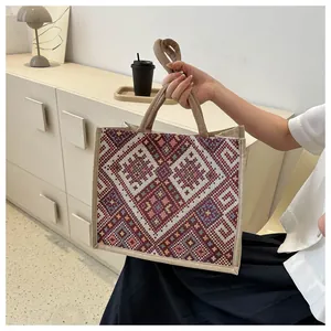 Ethnic style cotton linen tote bag with geometric patterns held by a model