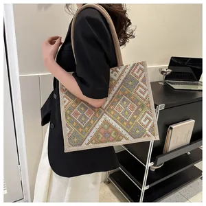 Detailed shot of ethnic tote bag showing colorful geometric patterns and rope handles