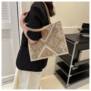 Close-up of ethnic geometric pattern woven tote bag with durable beige strap handles