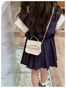 Detailed back view of a beige PU leather mini bag with a bow and wavy edge design