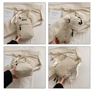 Detail view of beige corduroy crossbody bag showing logo patch and adjustable strap
