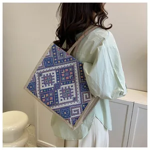 Detailed view of large ethnic tote bag with geometric embroidery and reinforced handles