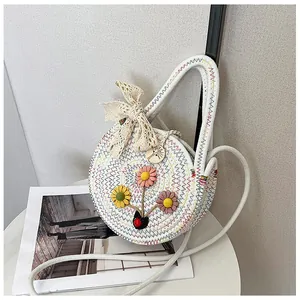 White round woven straw handbag with colorful embroidery and lace bow decoration