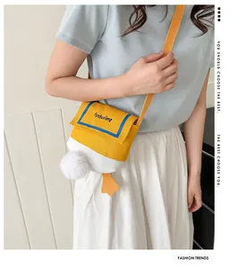 Detail of cute duck-shaped canvas crossbody bag showing plush tail and orange webbed feet