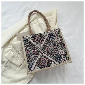 Detailed view of ethnic geometric pattern weaving on large cotton linen tote bag