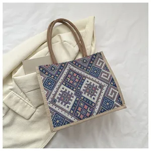 Close-up of ethnic geometric pattern on large linen tote bag with natural rope handles