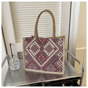 Macro detail of ethnic geometric weaving on cotton linen tote bag with sturdy rope handles