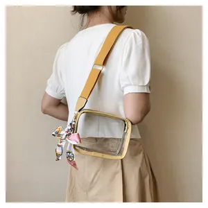 Detailed side view of clear PVC jelly crossbody bag with yellow strap and printed silk scarf