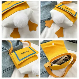 Detail showing the cartoon duck canvas crossbody bag with fluffy tail and magnetic buckle