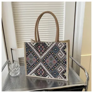 Detailed texture of ethnic geometric embroidery on high-quality jute tote bag