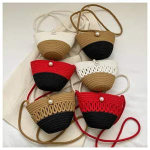 Detail of six hand-woven mini crossbody bags with pearl button closure and colorful patterns