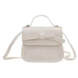 Chic cream white mini handbag with a bow detail for girls, featuring a textured PU leather finish