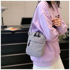 Gray corduroy crossbody phone bag for women shown as a stylish shoulder bag detail